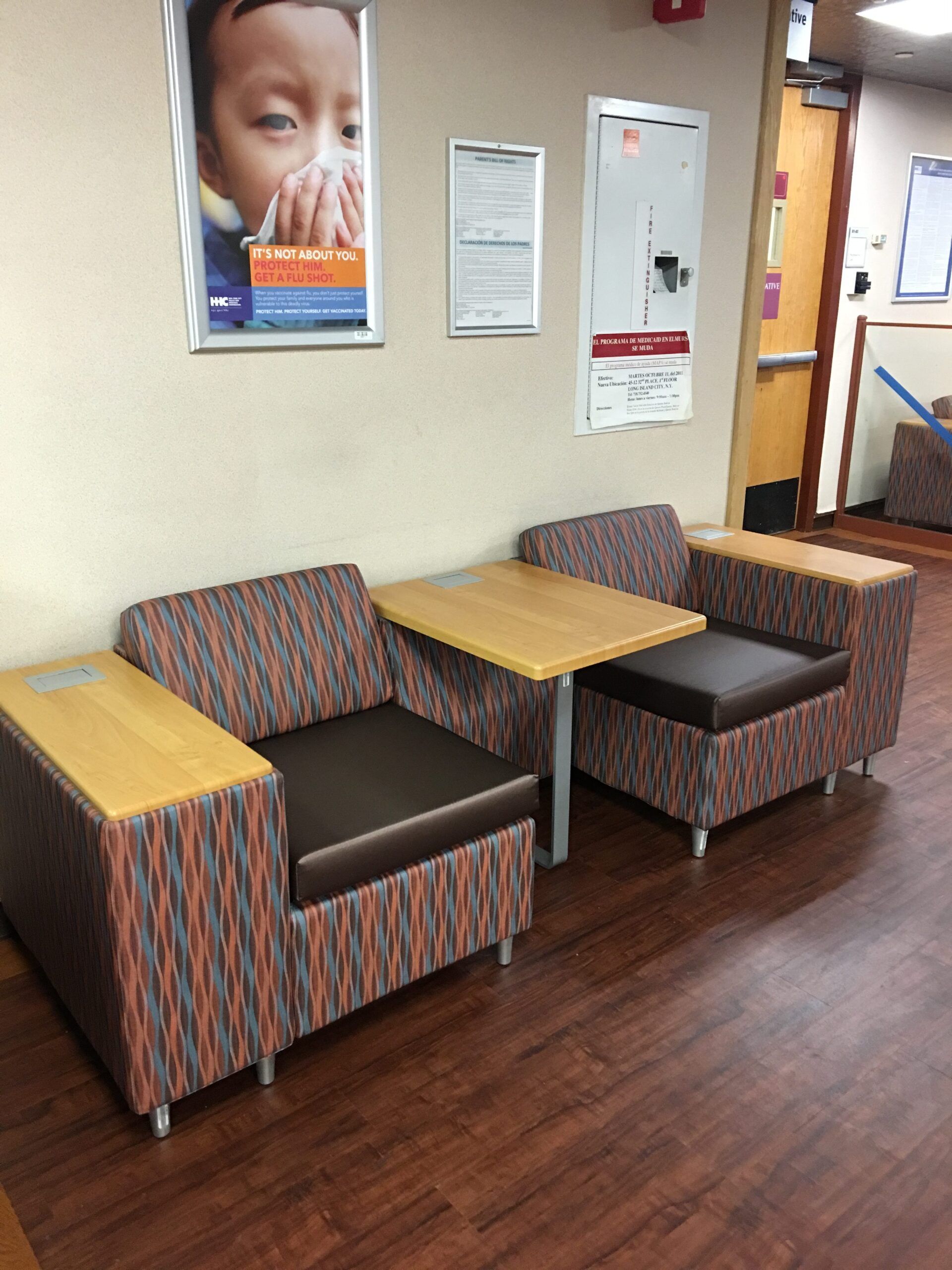 A room with chairs and tables and a picture of a child on the wall