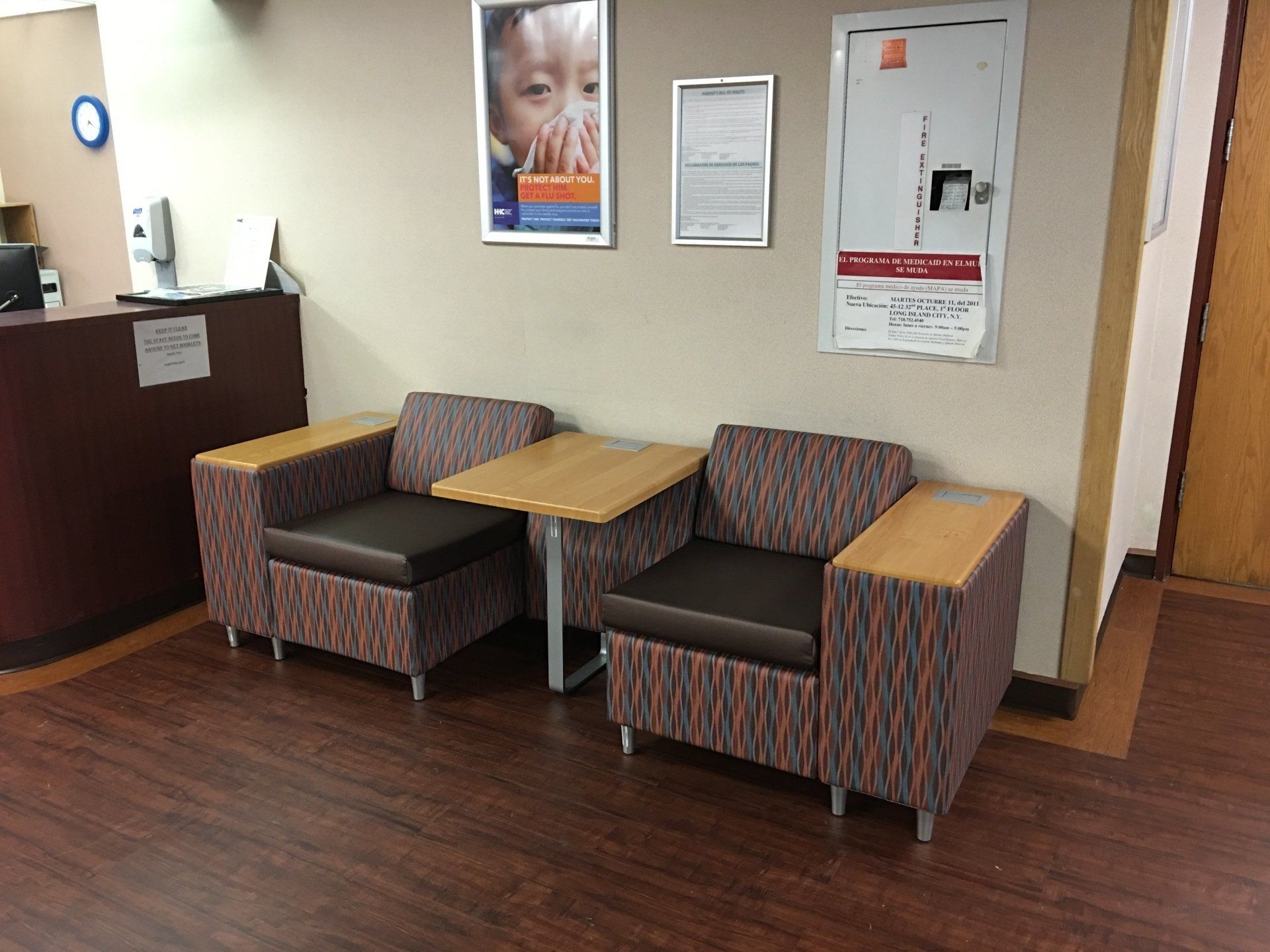 A waiting room with two chairs and a table