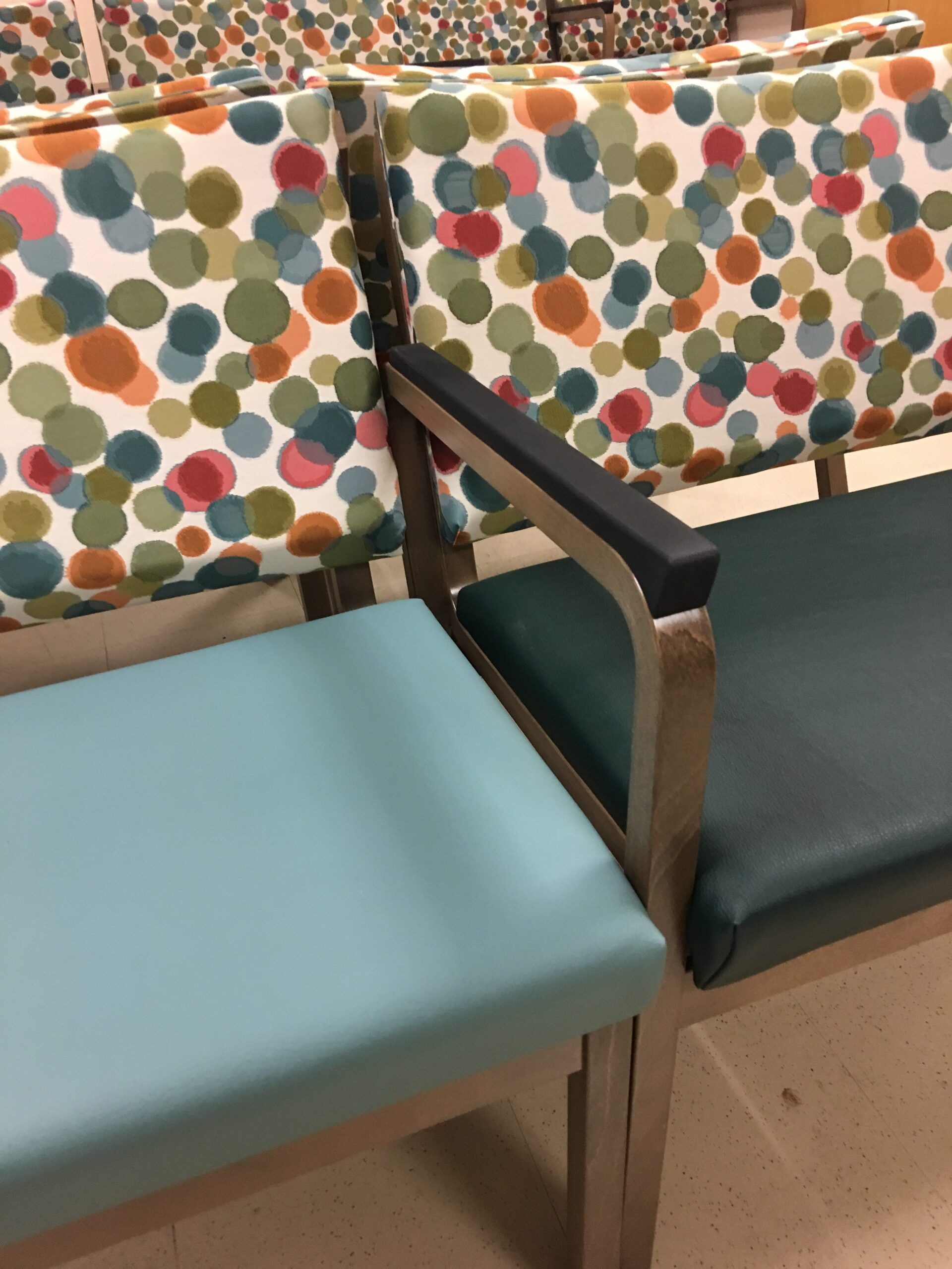 A row of chairs with colorful polka dots on them