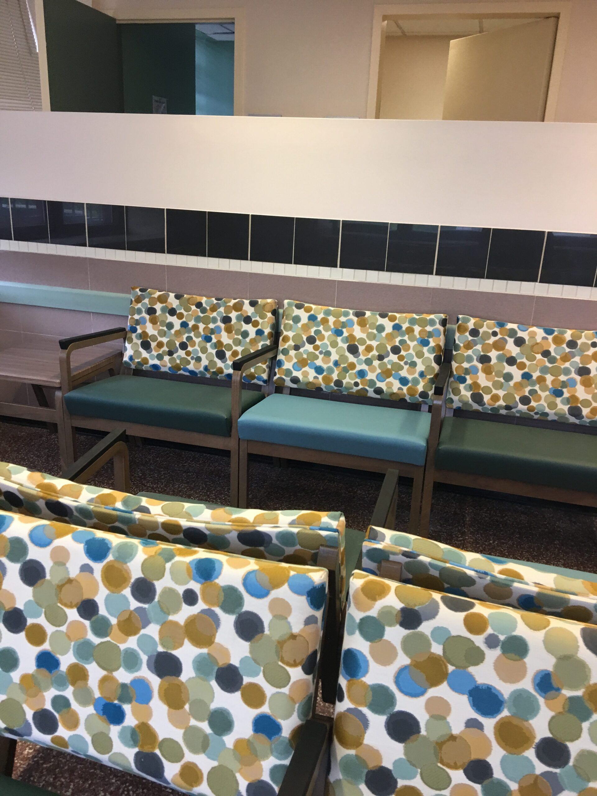A row of colorful chairs in a waiting room