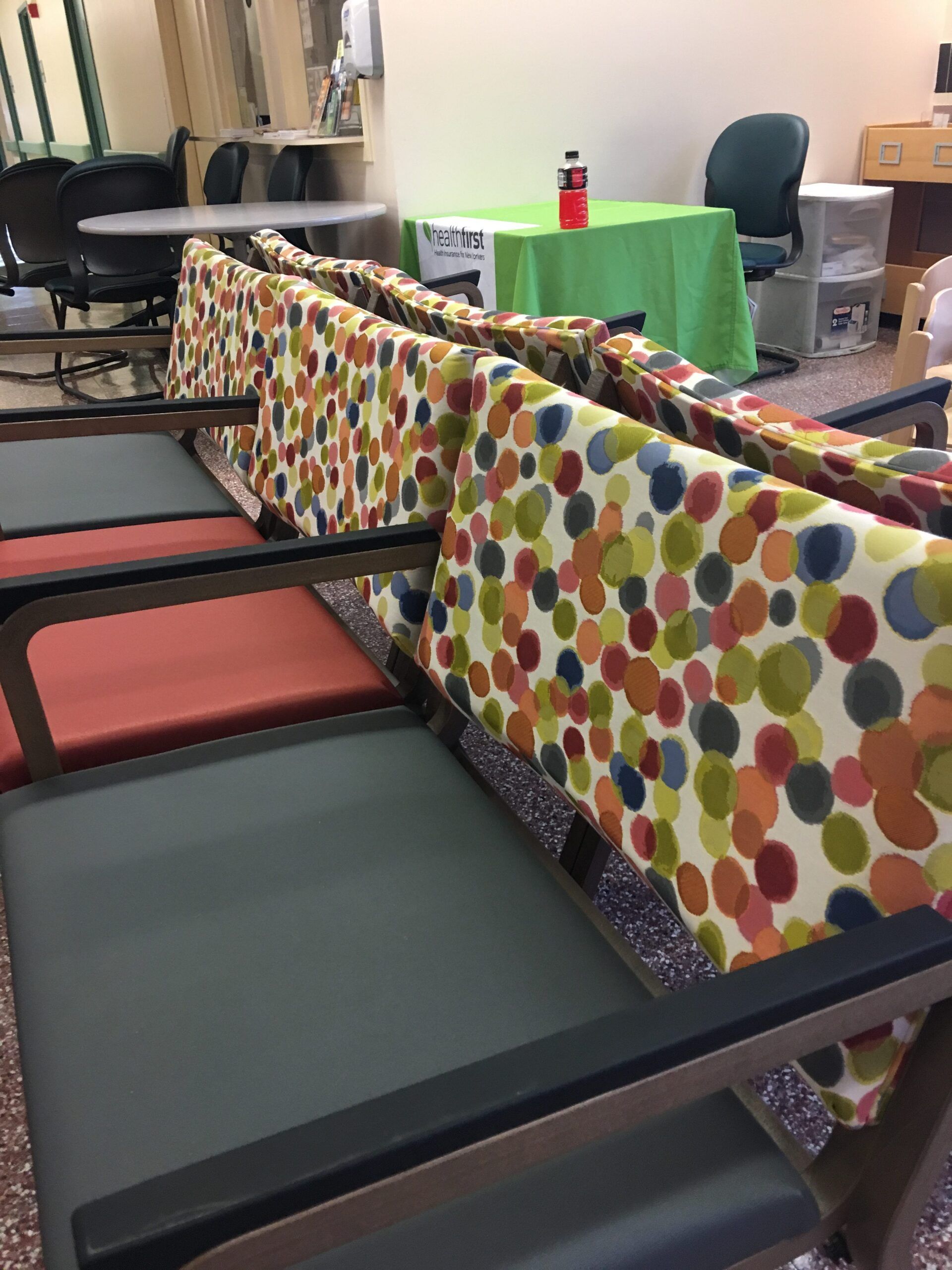A row of colorful chairs in a waiting room