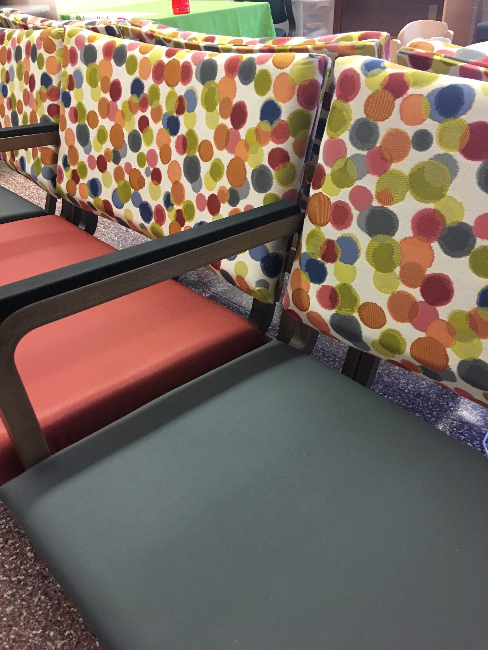 A row of colorful chairs with polka dots on them