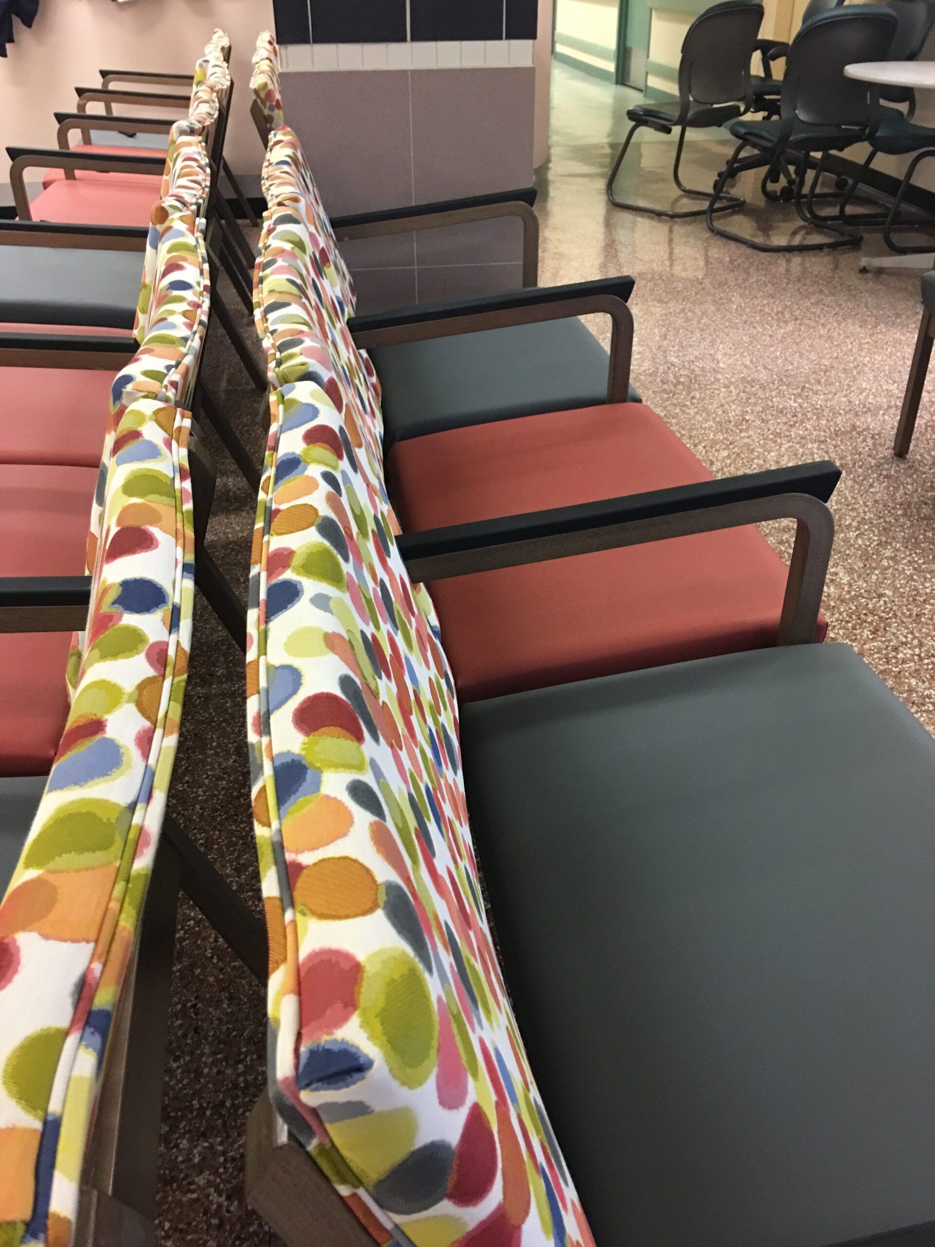 A row of colorful chairs in a waiting room