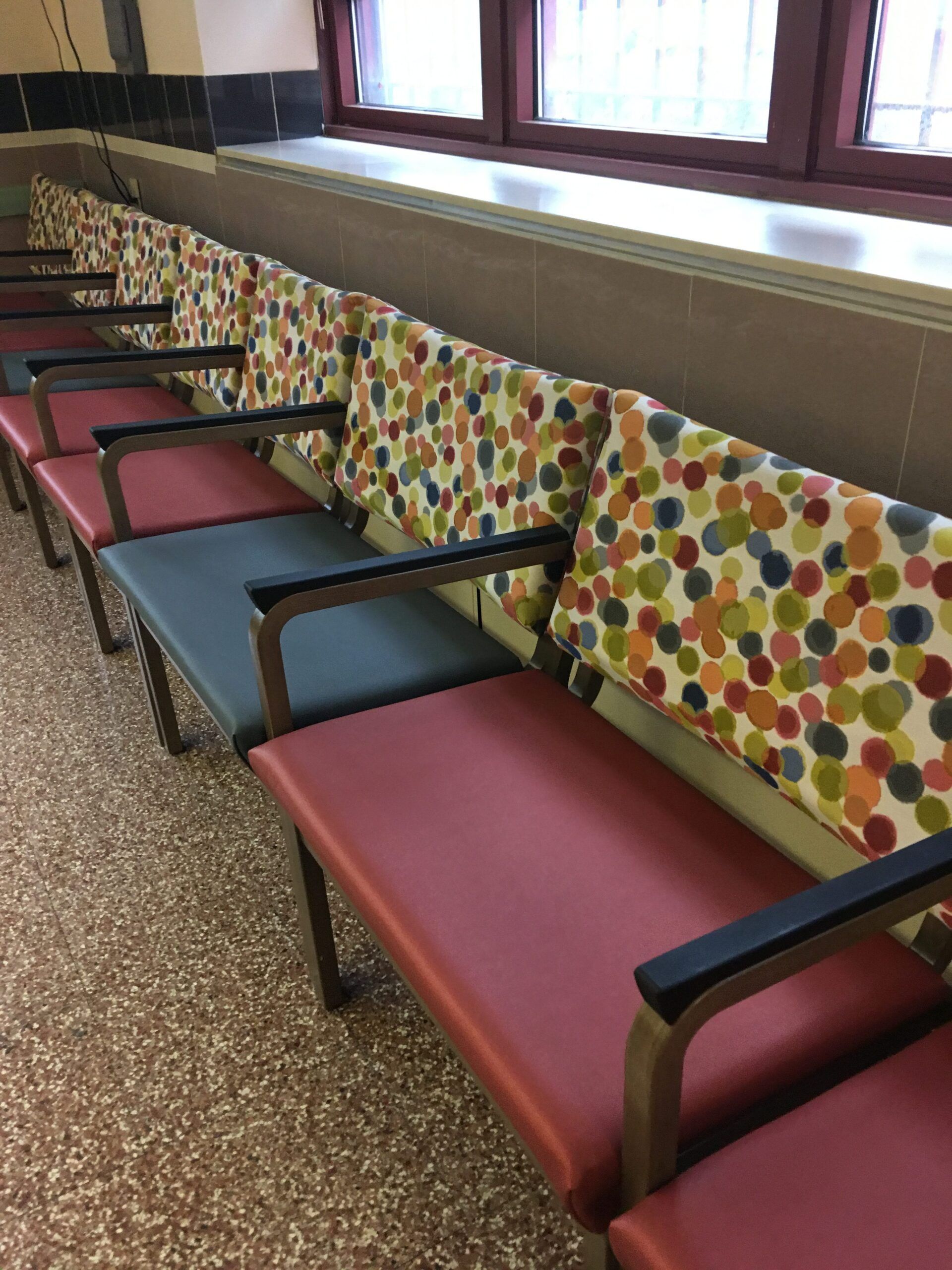 A row of colorful chairs in a waiting room