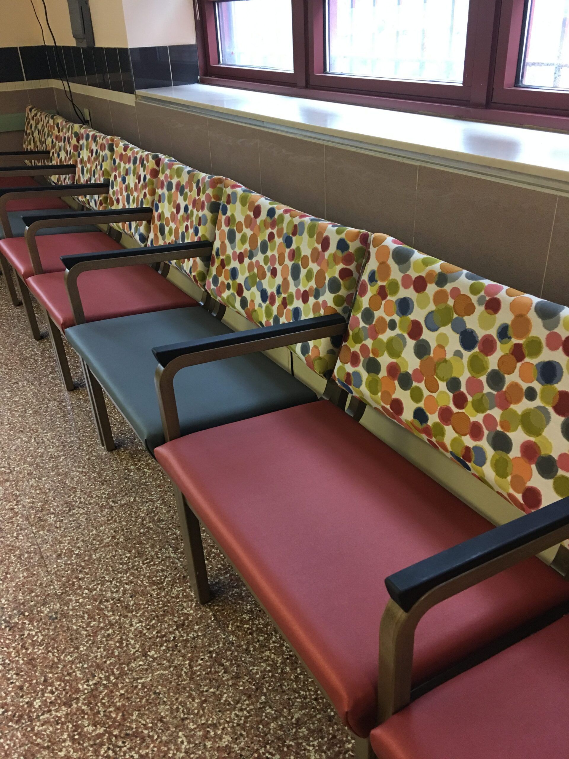 A row of colorful chairs in a waiting room