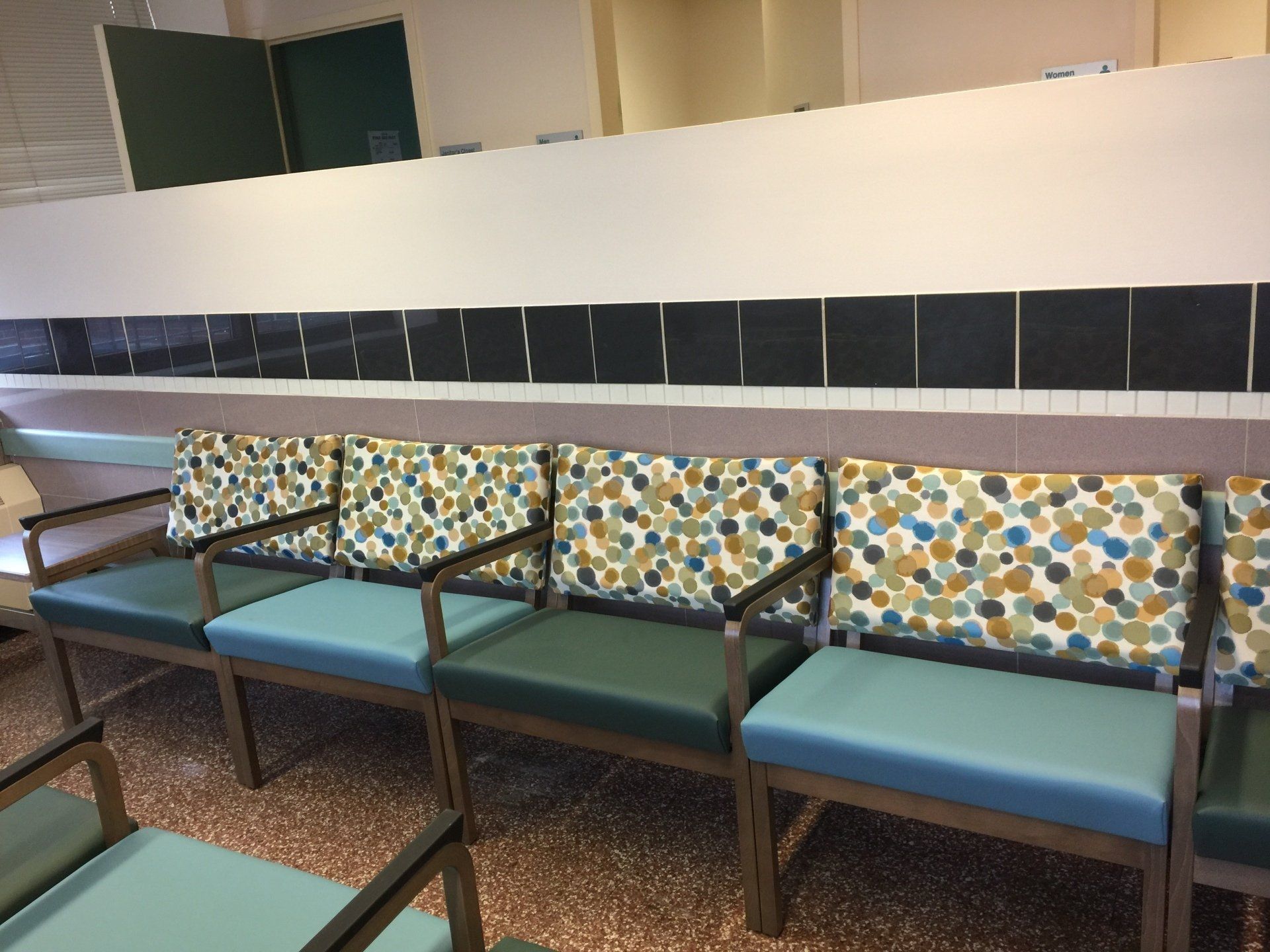 A row of colorful chairs in a waiting room