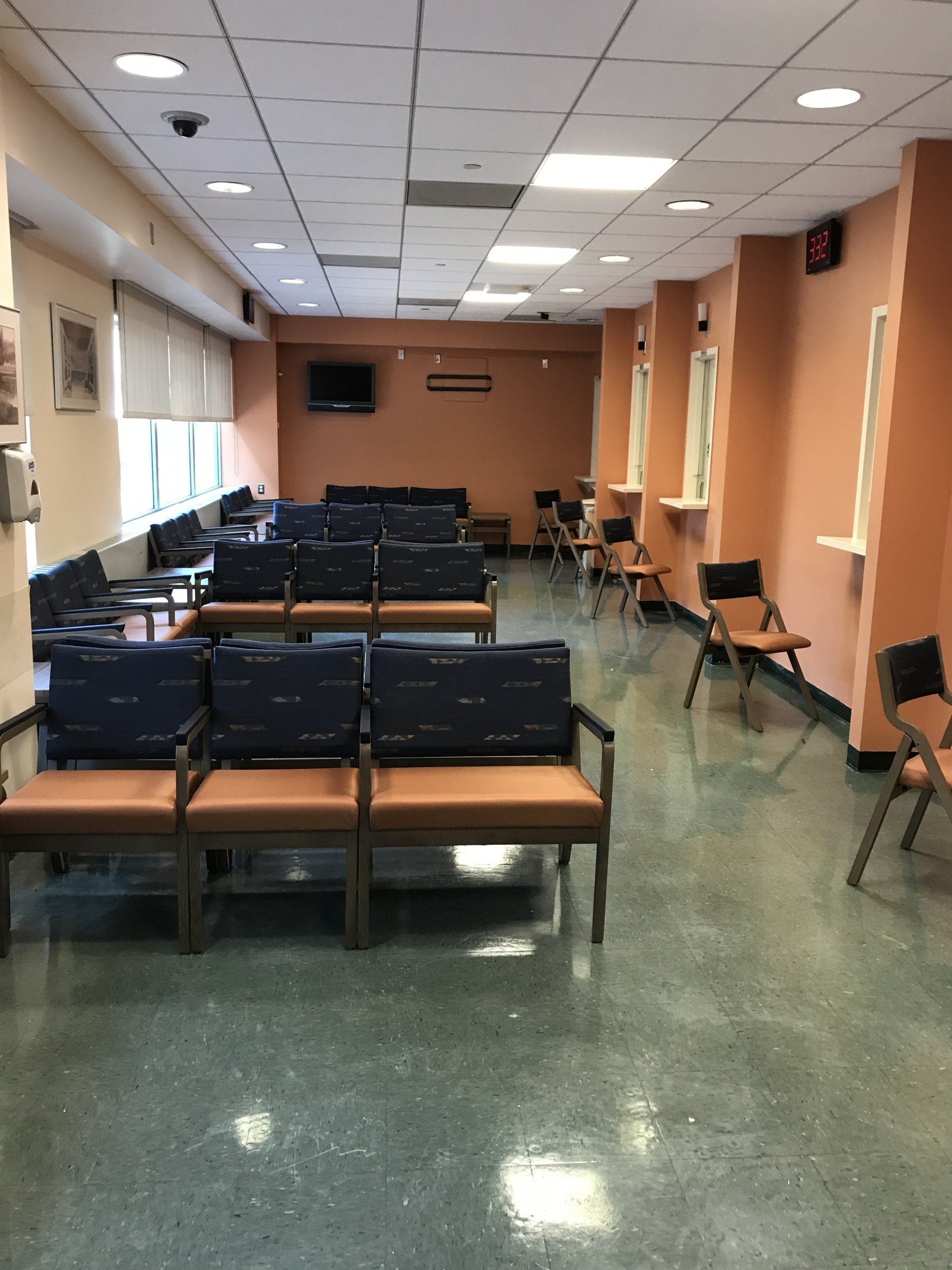 A waiting room with lots of chairs and benches