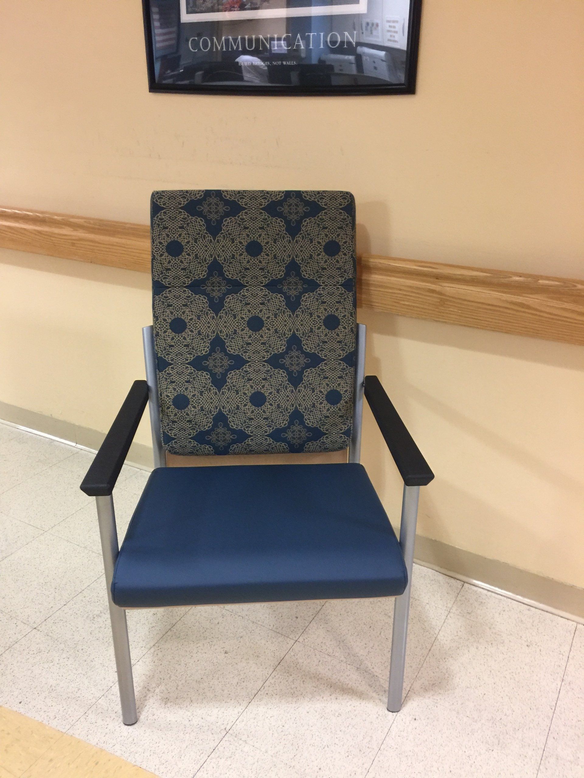 A chair in a hallway with a picture on the wall that says consultation
