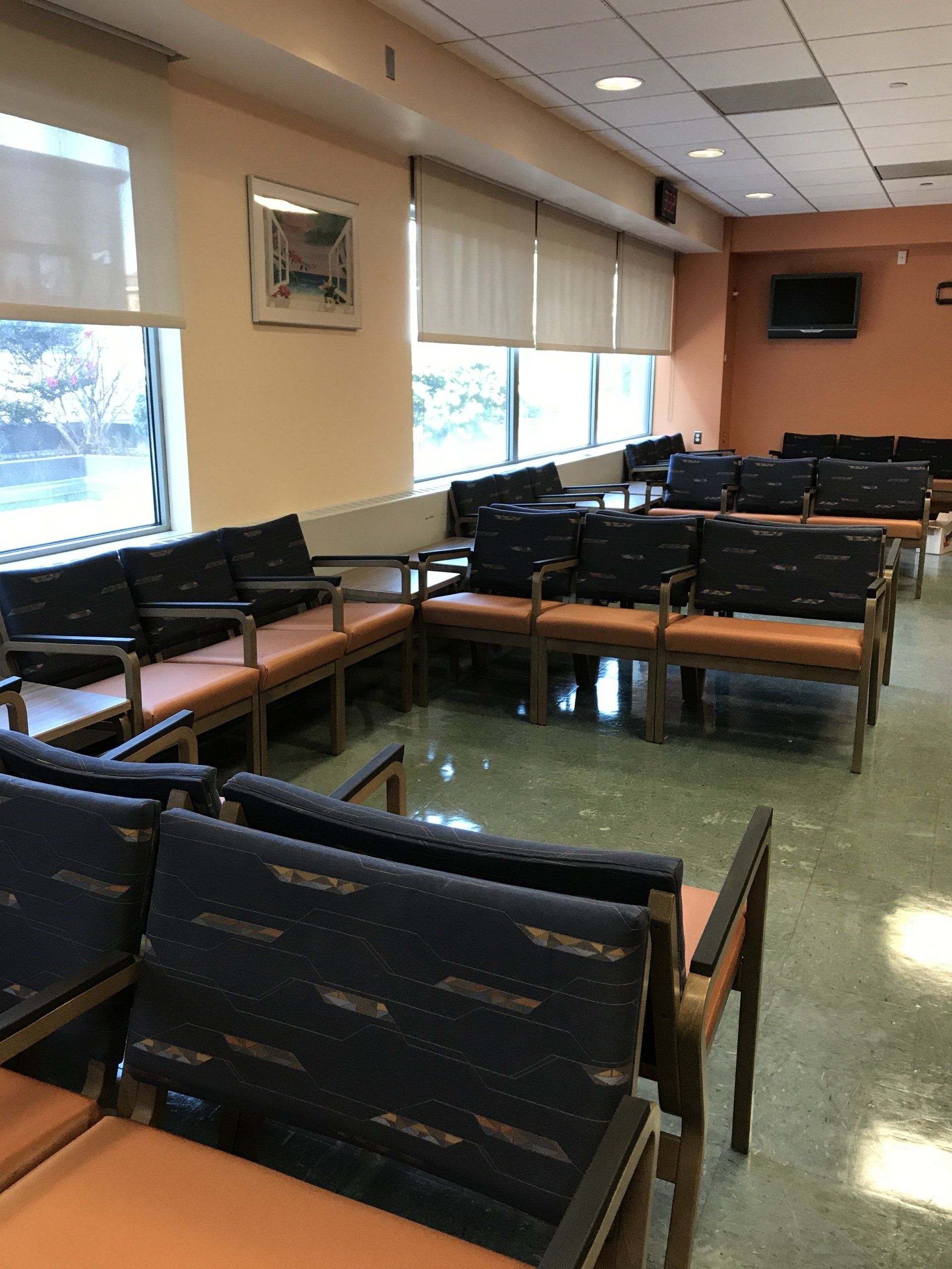 A waiting room with a lot of chairs and windows