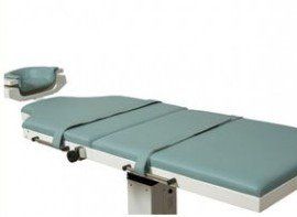 A medical table with a blue mattress and a pillow on it.