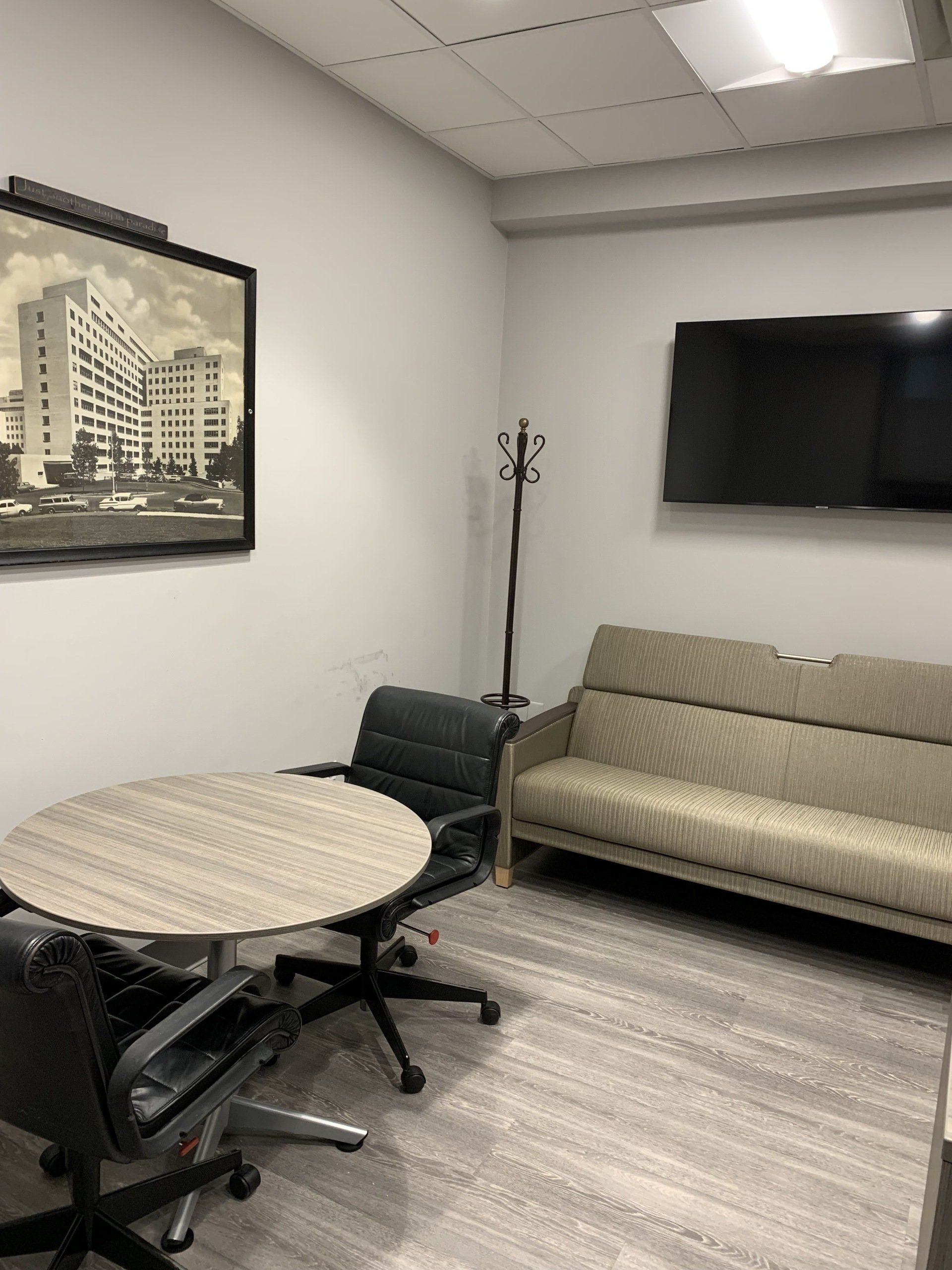 A room with a couch a table and a television