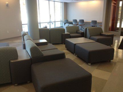 A room with a lot of chairs and ottomans