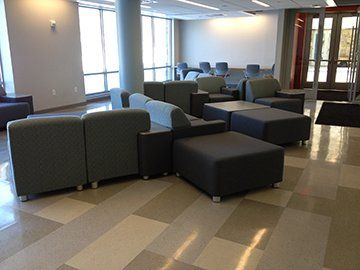 A room with a lot of chairs and ottomans