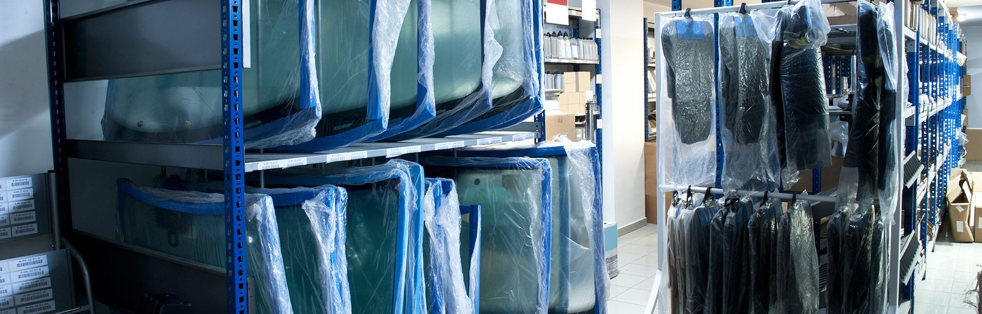 A warehouse filled with shelves filled with lots of glass.