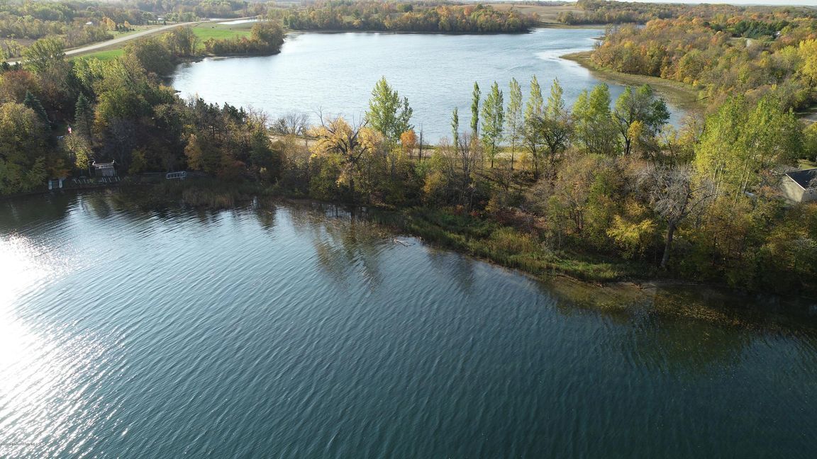 An aerial view of a large lake surrounded by trees.