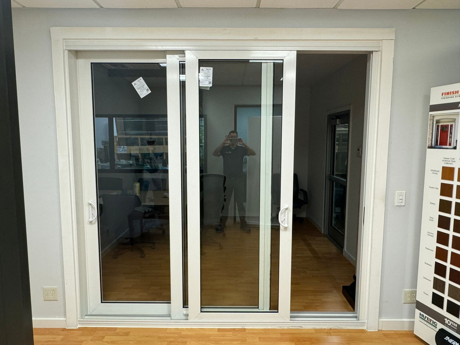 White triple-pane sliding glass door in a showroom. 