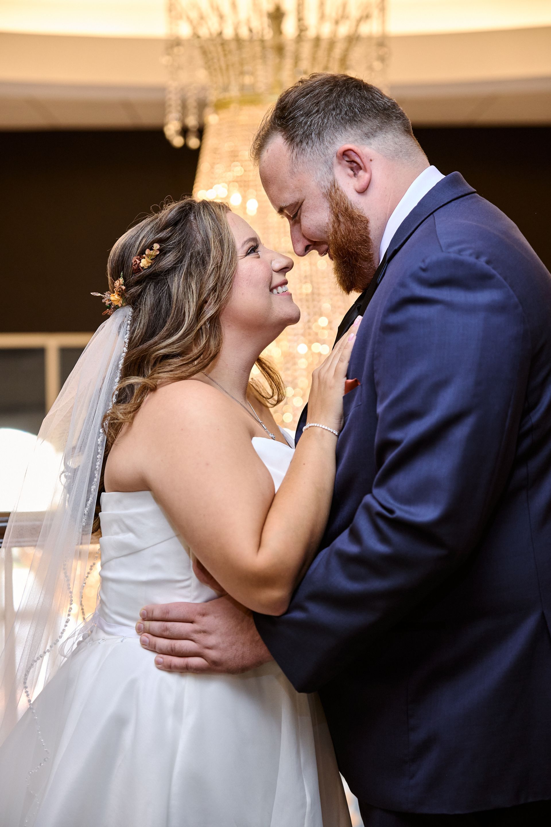 Bride and groom with chandelier 