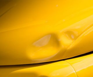 Zoom Photo Of A Yellow Car With Dent — Columbus, OH — Kraft’s Body Shop