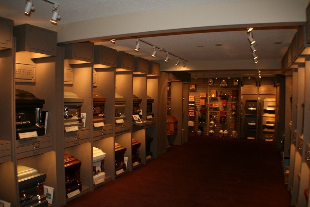 Interior of a bookstore aisle with shelves of books and warm overhead lighting