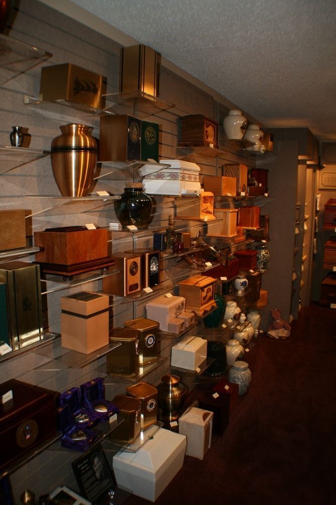 Shelves lined with assorted decorative boxes and home goods in a dim store aisle