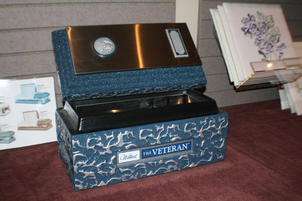 Blue accordion with white labels on a table next to a folded card display
