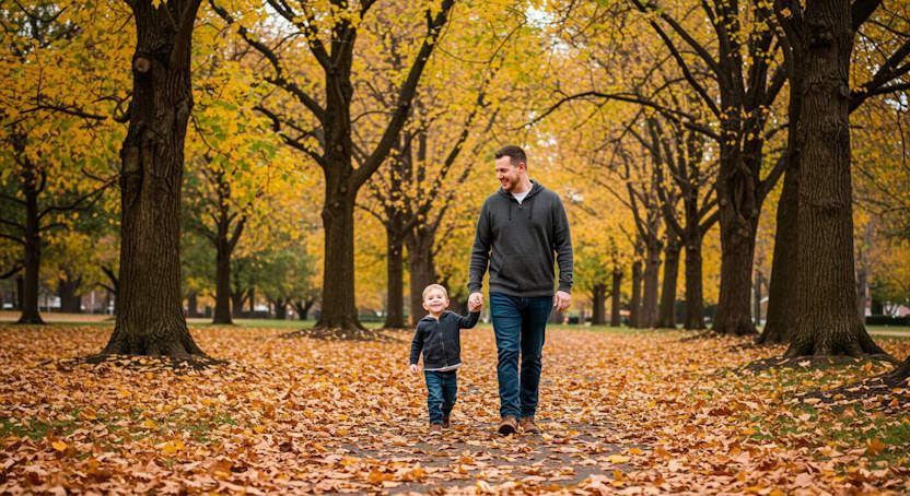 Dad walking in a Columbus park with his son with a relaxed and relieved expression after quit smoking hypnosis