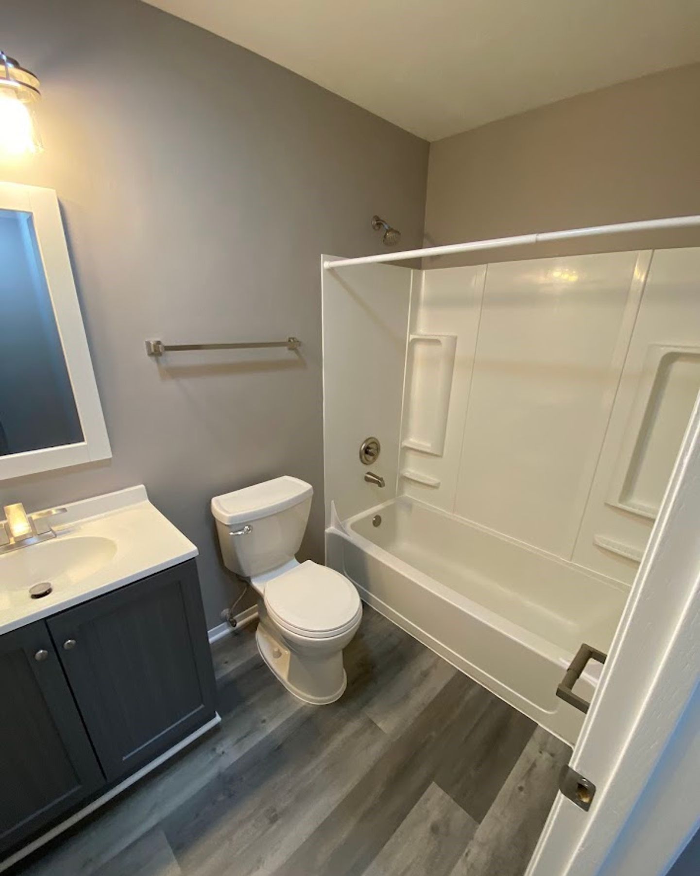 A bathroom with a toilet , sink , and bathtub.
