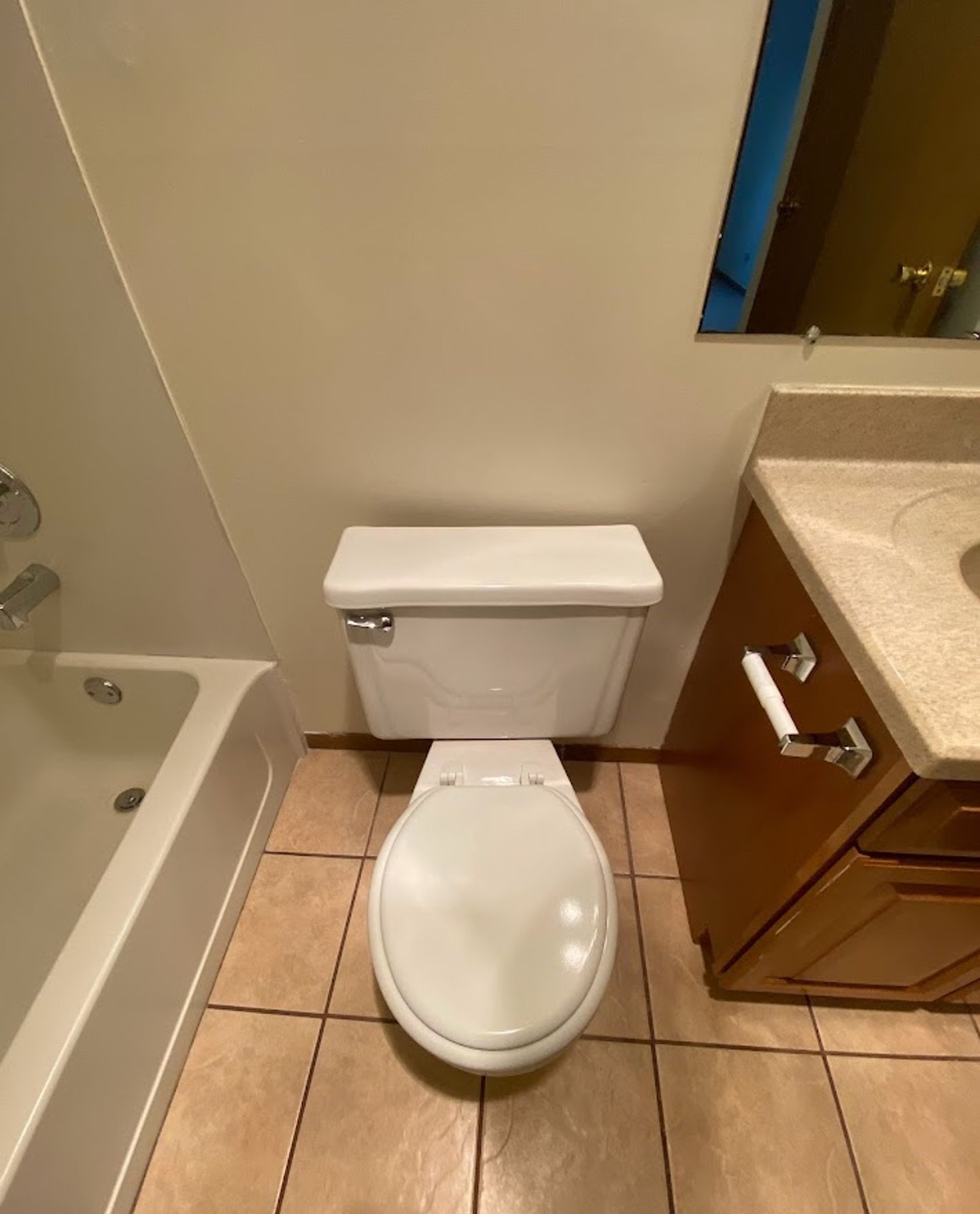 A bathroom with a toilet , sink and bathtub.