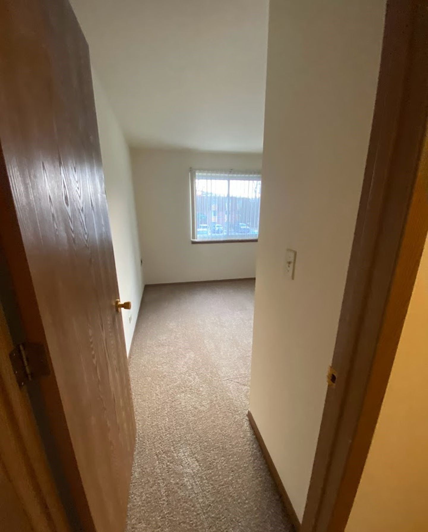 A doorway leading to a bedroom with a window.