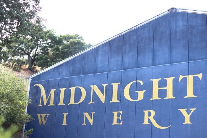 A dark blue wall featuring the name 