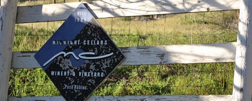 A diamond-shaped black sign for 