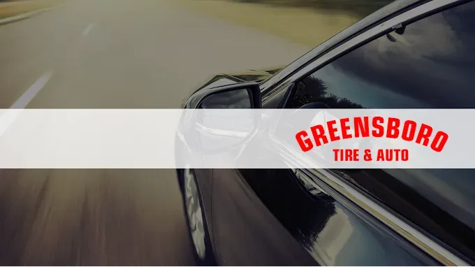 Car driving on road, Greensboro Tire & Auto logo overlaid.