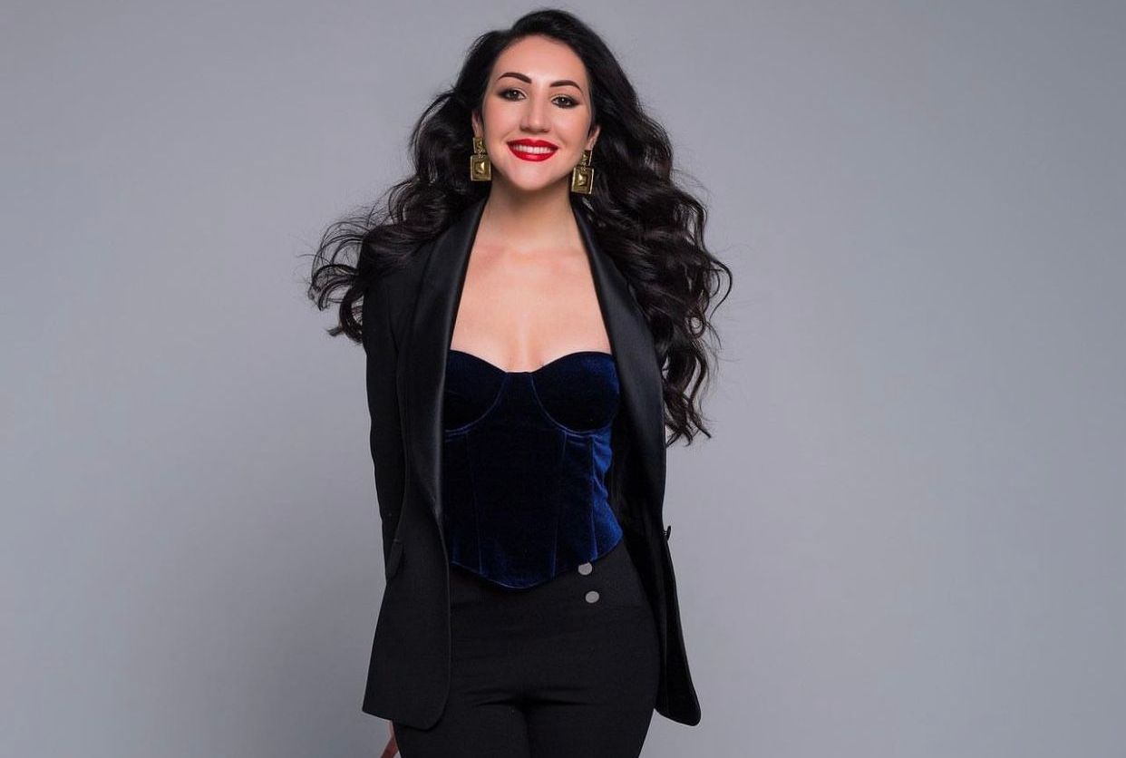 Professional photographer using a high-end camera to capture a portrait, focusing on artistic composition and the perfect play of light.