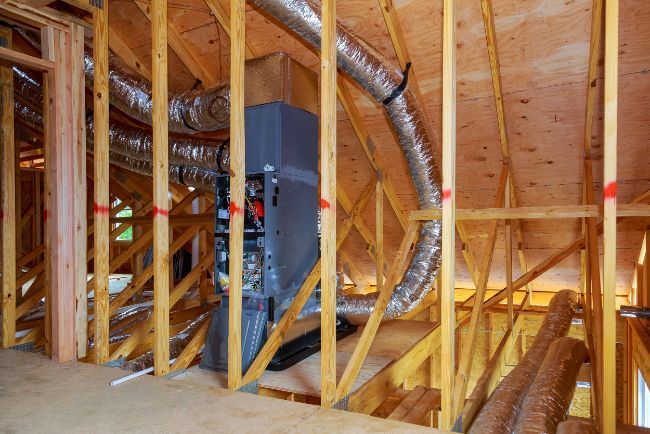A house is being built and there is a heater in the attic.