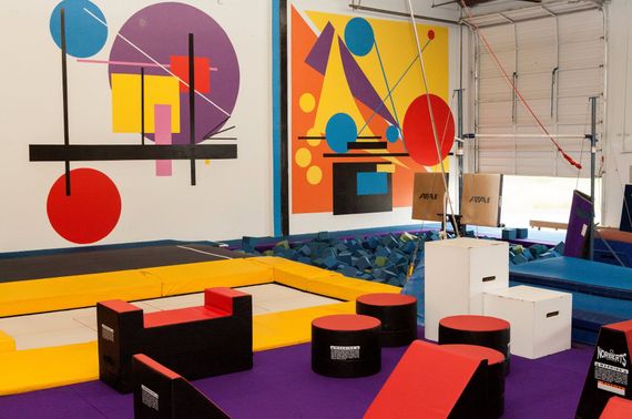 A gym with a colorful mural on the wall