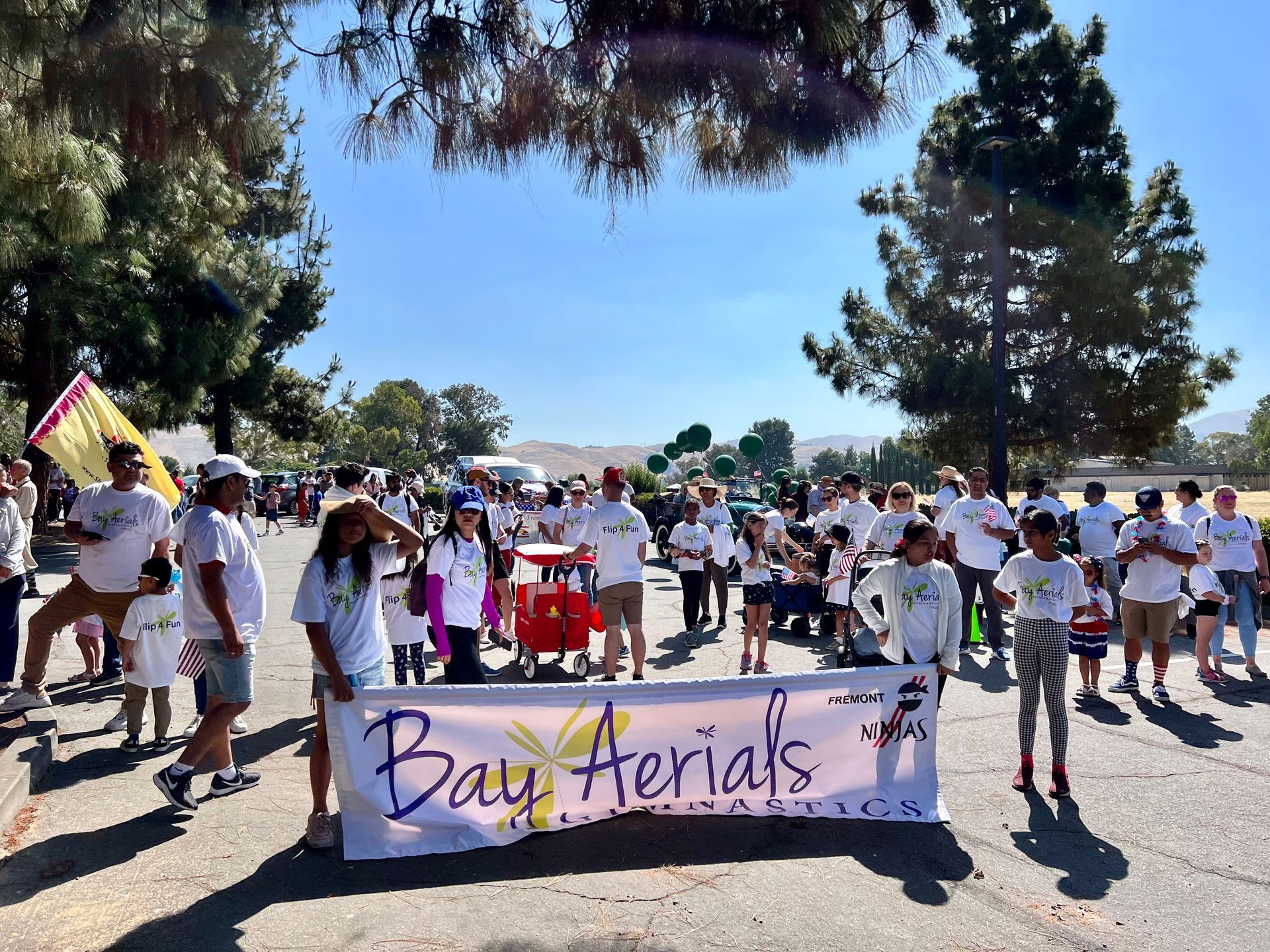 People walking in a park, holding a 