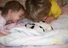 Kid kissing the puppy — Abilene, KS — Paws -N-Claws