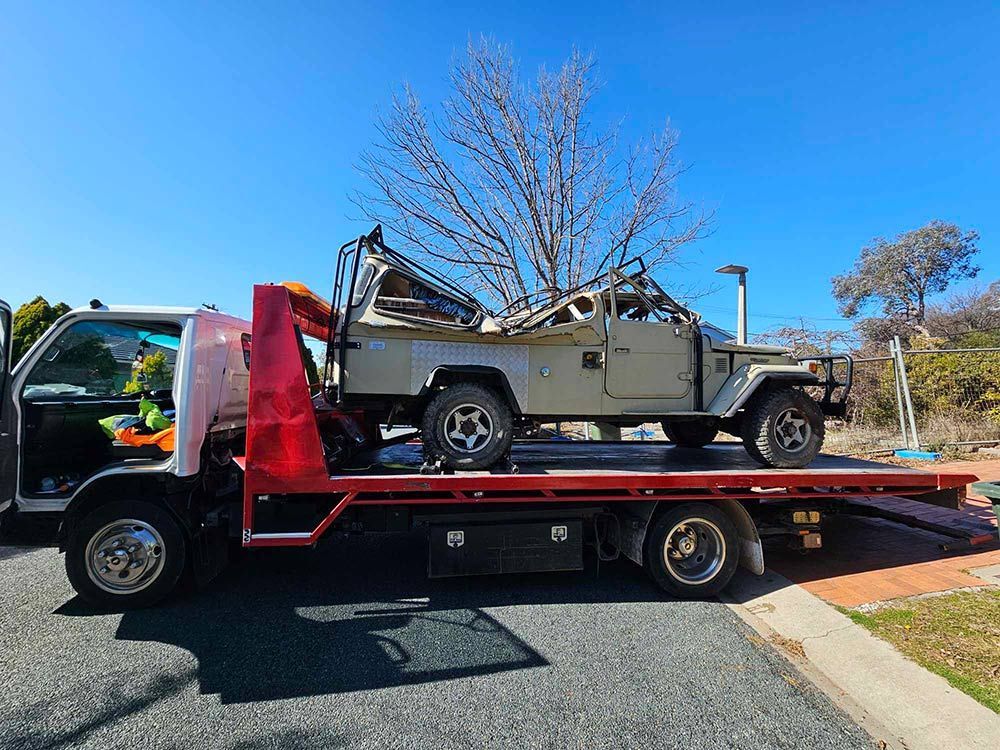 A Tow Truck Is Carrying A Damaged Jeep - All Recovery Towing & Transport in Richardson ACT
