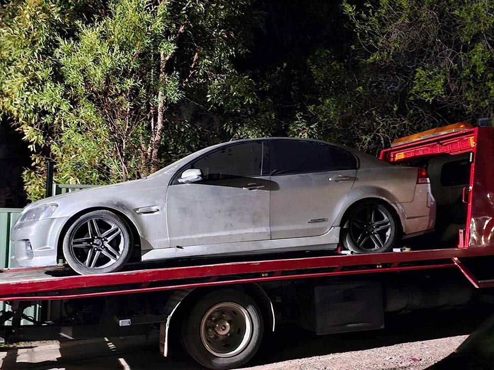 A Silver Car Is Sitting On Top Of A Tow Truck - All Recovery Towing & Transport in Richardson ACT