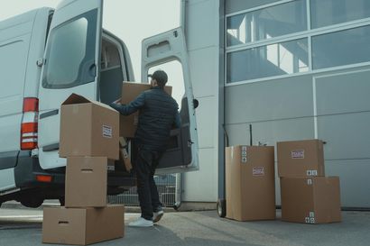 Man loading box van with boxes