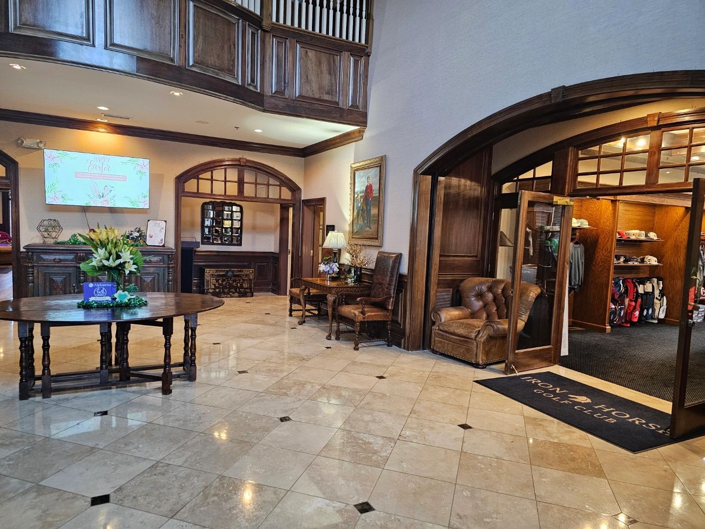 Elegant lobby with wood paneling, marble floor, furniture, and a shop entrance. Elegant lobby with wood paneling, marble floor, furniture, and a shop entrance.