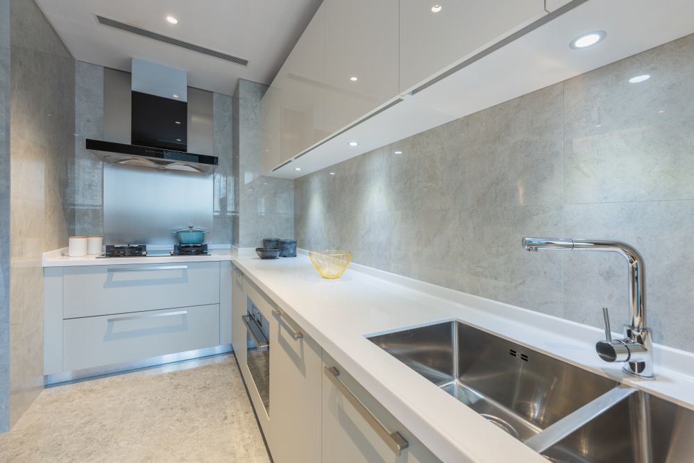 A Kitchen With White Cabinets and a Stainless Steel Sink — Northern Tile Gallery in Winnellie, NT