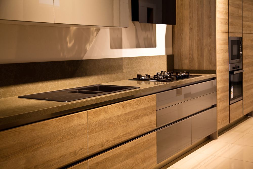A Kitchen With Wooden Cabinets and Stainless Steel Appliances — Northern Tile Gallery in Winnellie, NT