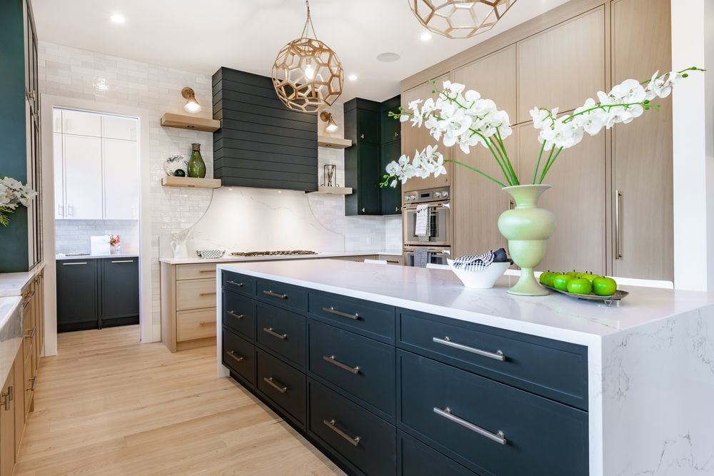 A Kitchen With a Large Island and a Vase of Flowers on the Counter — Northern Tile Gallery in Winnellie, NT
