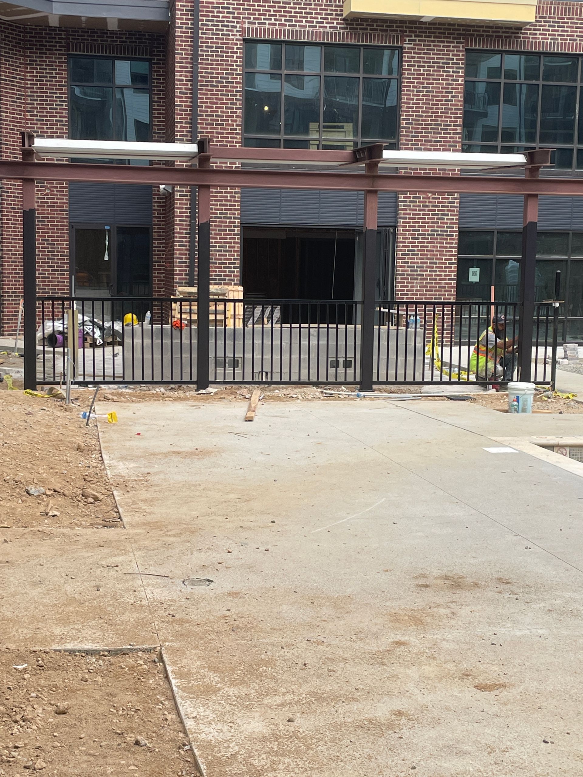 A brick building with a fence in front of it