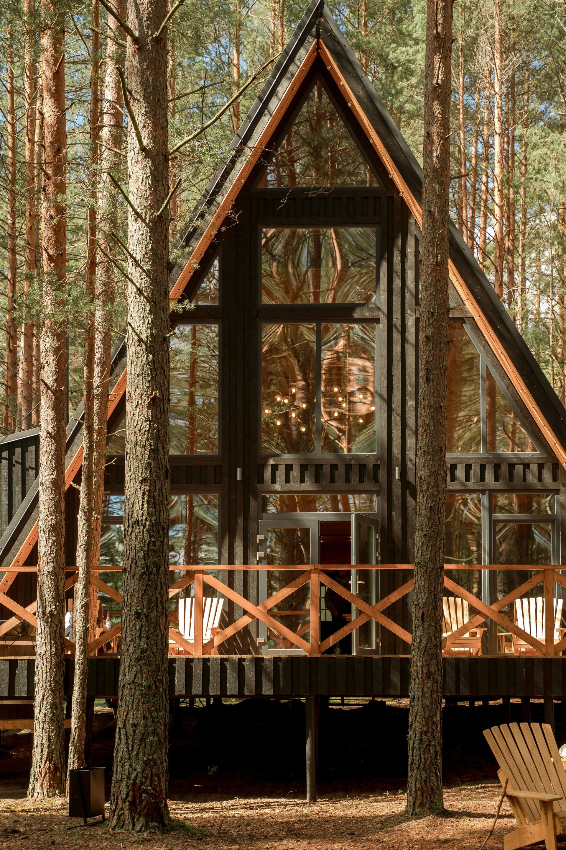 A small house in the middle of a forest surrounded by trees.