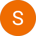 The letter s is in an orange circle on a white background.