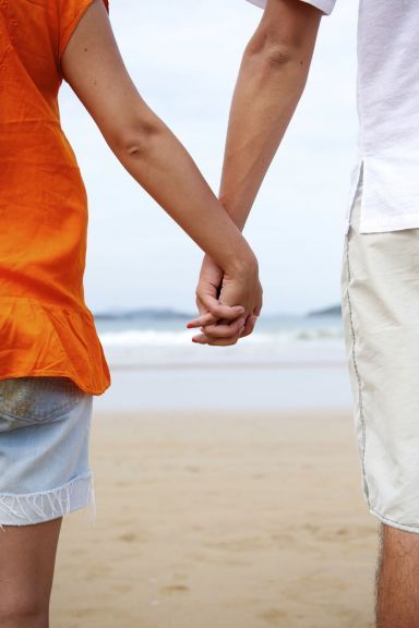 Holding hands on the beach after therapy at a psychology centre in Melbourne
