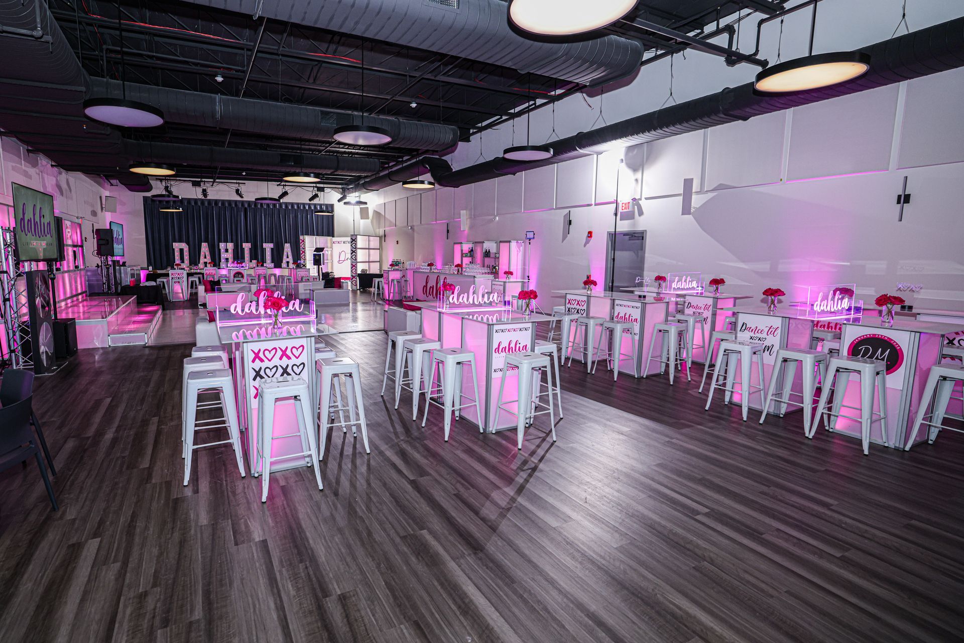 A large room with tables and chairs set up for a party.