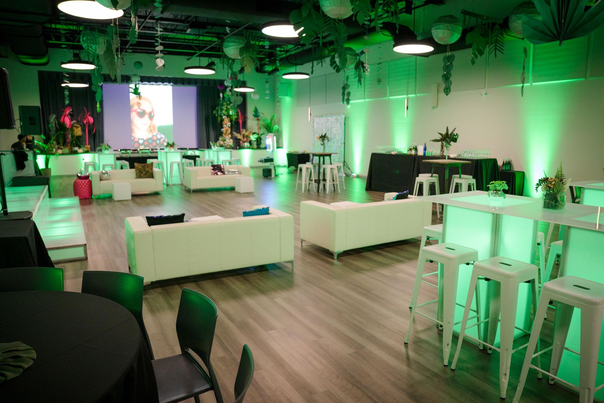 A large room filled with furniture and tables with green lights.